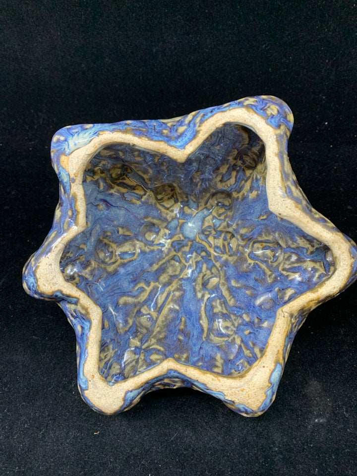 CERAMIC ART WITH TEXTURED BLUE AND BROWN GLAZE.