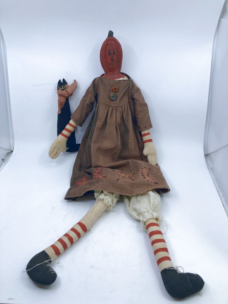 PRIMITIVE PUMPKIN MAN HOLDING BLACK CAT.