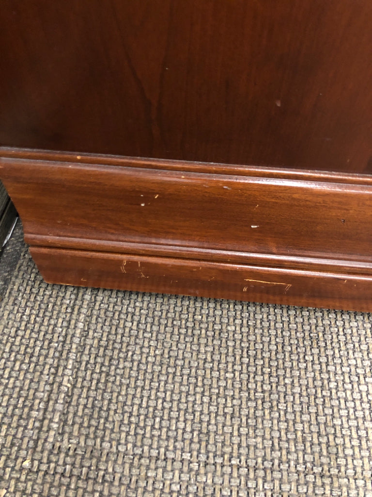 DARK CHERRY SIDE TABLE W/VTG METAL HANDLES & GLASS COVER ON WHEELS.