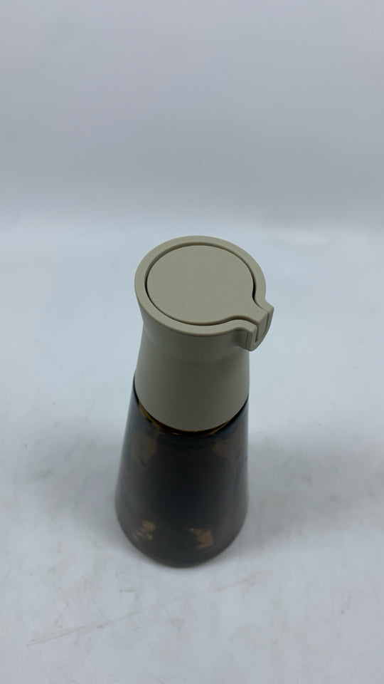 BROWN GLASS BOTTLE W/PLASTIC POUR SPOUT.