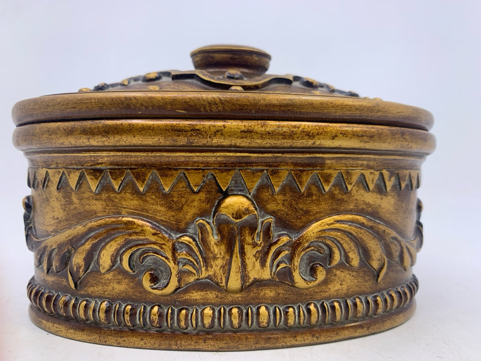 OVAL HEAVY BRONZE/GOLD EMBOSSED SCROLL COVERED TRINKET BOX.