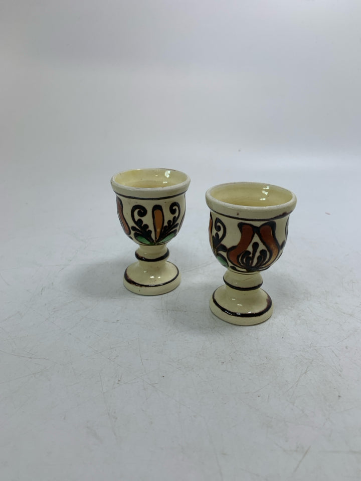 VTG 2 SMALL FOOTED YELLOW EGG CUPS W/ BROWN DETAIL.