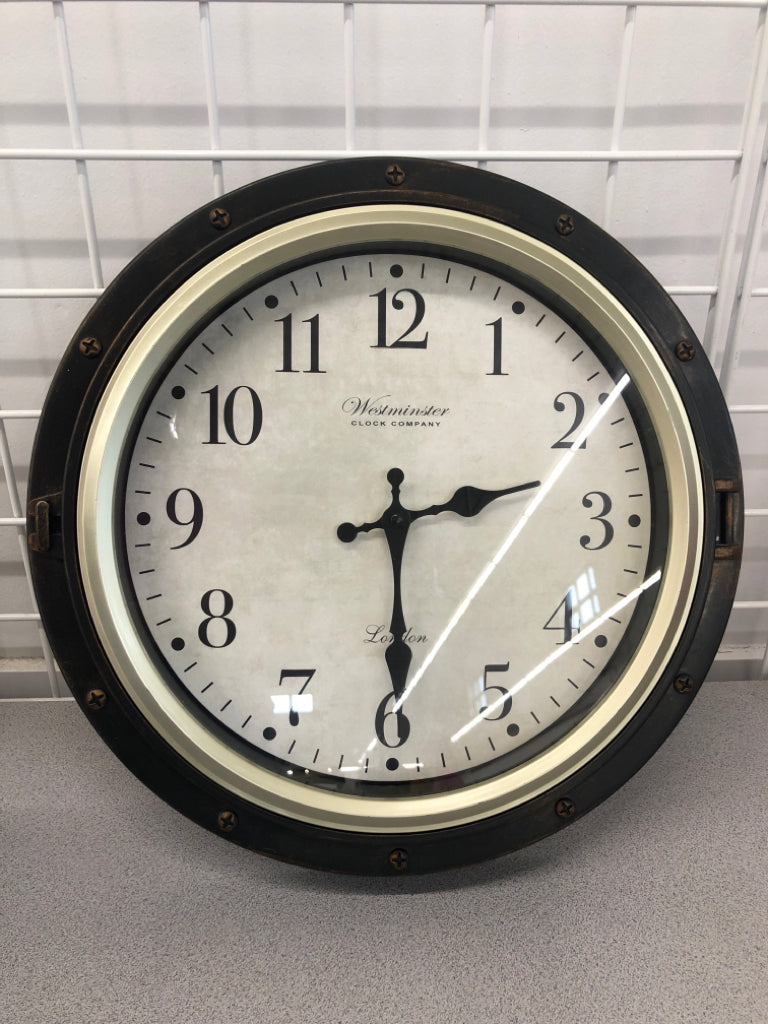 ROUND BROWN PLASTIC WALL CLOCK.