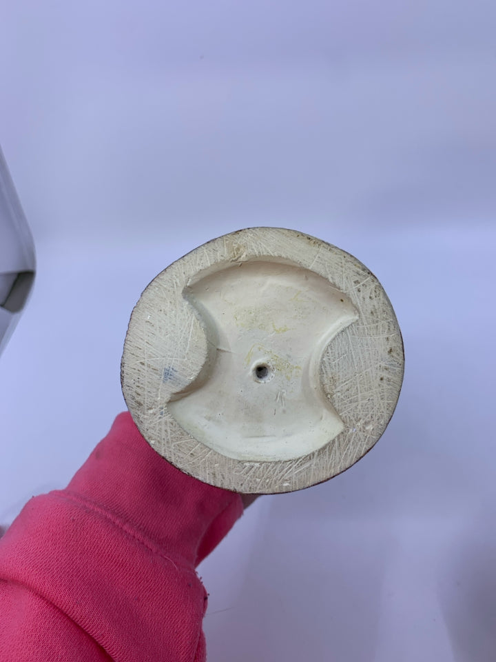 MAN PLAYING ACCORDION LEANING ON TREE.