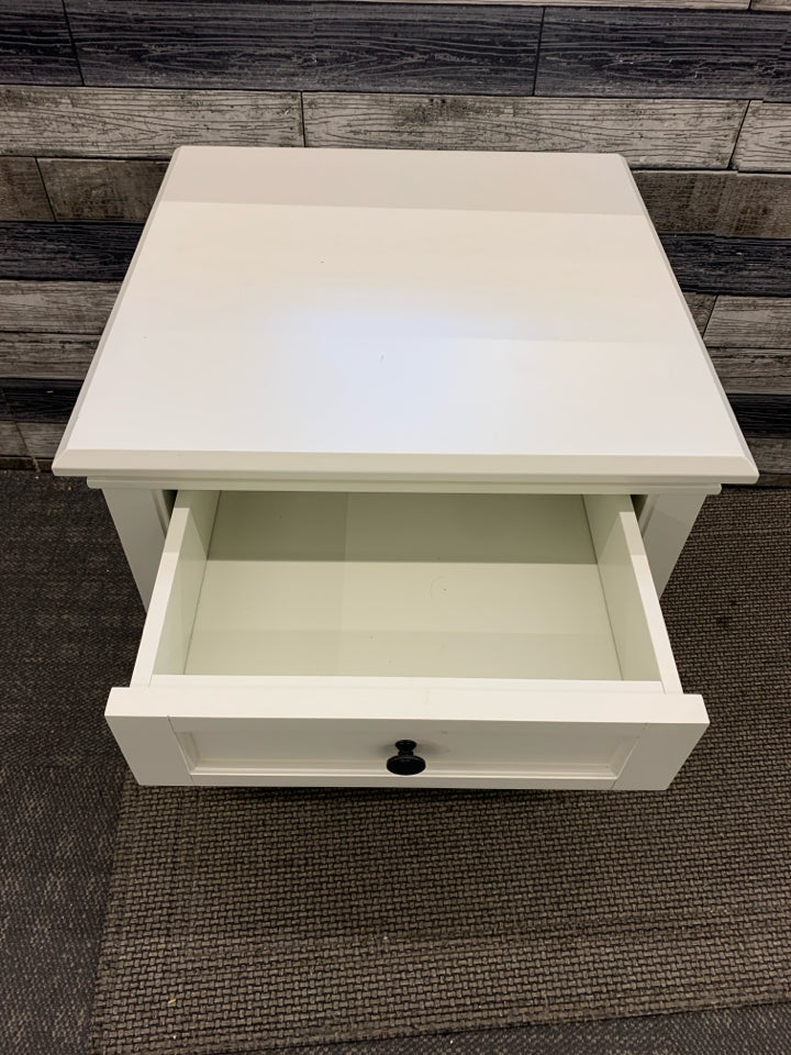 WHITE NIGHT STAND W/ DRAWER BLACK HARDWARE.