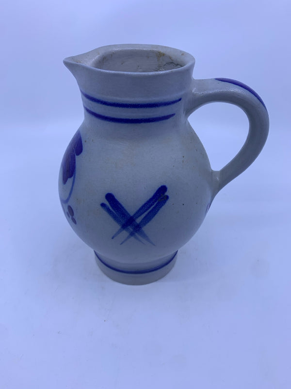 BLUE PAINTED STONEWARE PITCHER .