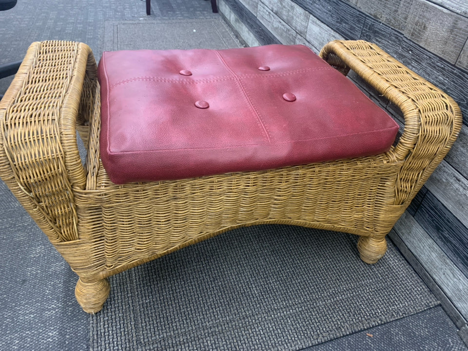WICKER FOOT STOOL BENCH AND RED CUSHION.