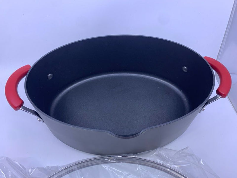 NEW OVAL PAN W/ LID NON STICK RED HANDLES.