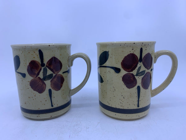 2 TAN WITH BROWN FLORAL AND SPECKLED MUGS.