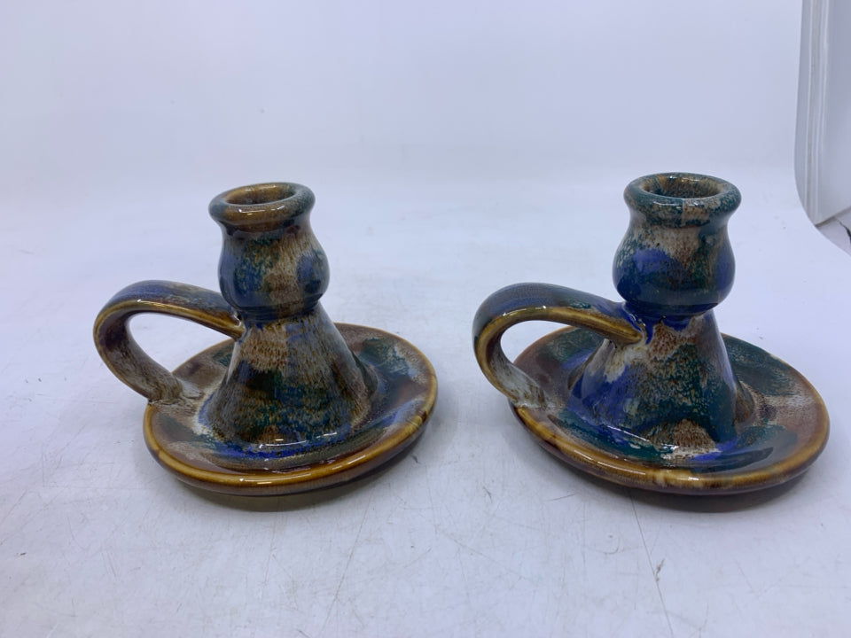 2 BROWN WHITE GREEN GLAZED TAPERED CANDLE HOLDERS W/ HANDLES.