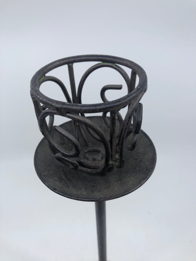 TALL GRAY METAL CUTOUT CANDLE HOLDER.