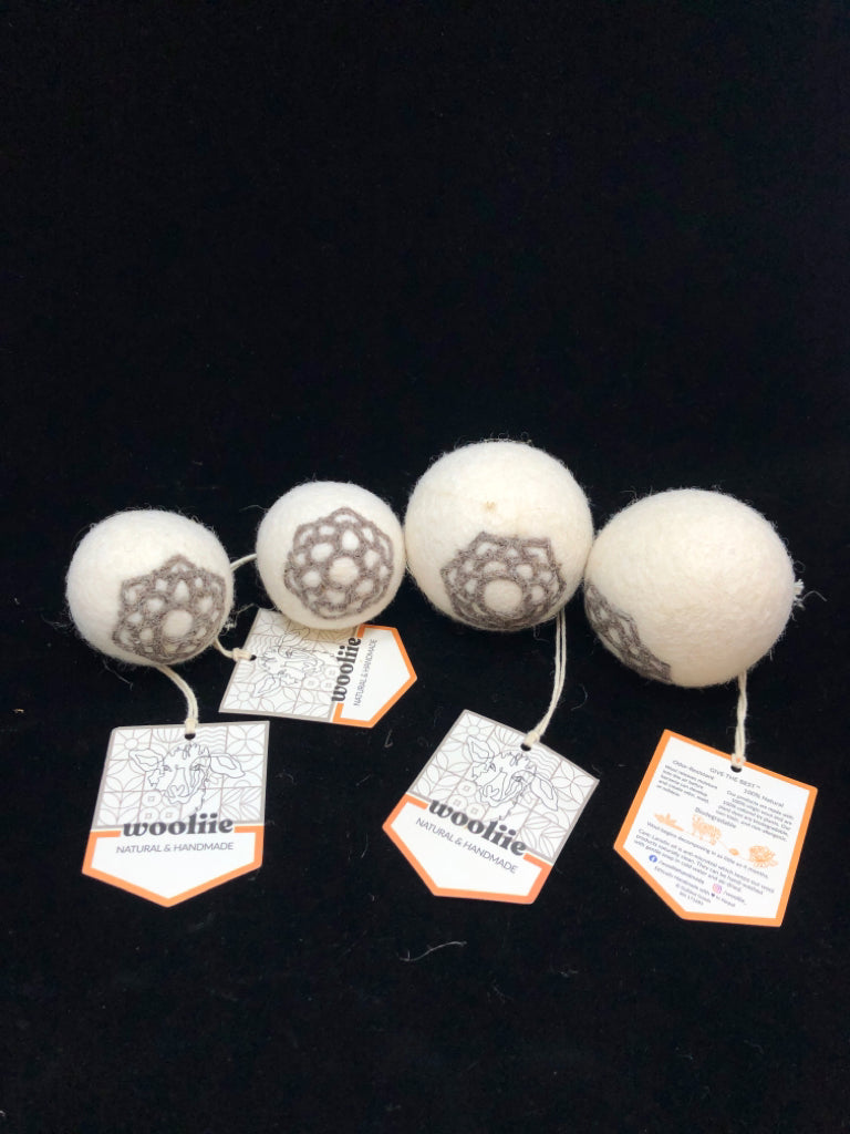 4 EMBROIDERED WOOLIIE WOOL DRYER BALLS IN BAG.