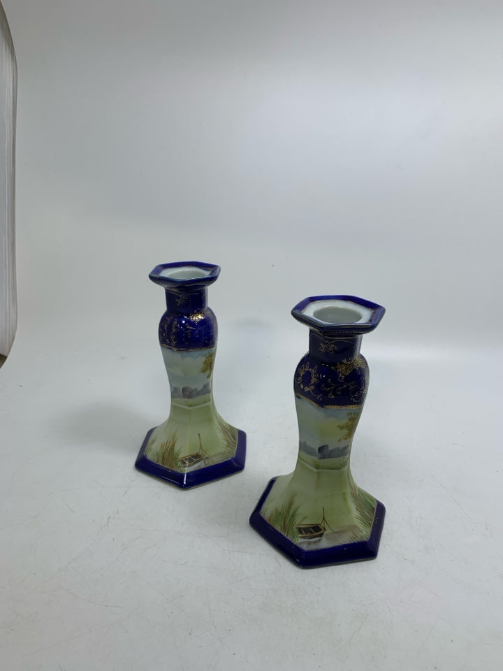 2 CERAMIC COBALT BLUE W/ SCENE TAPERED CANDLE HOLDERS.