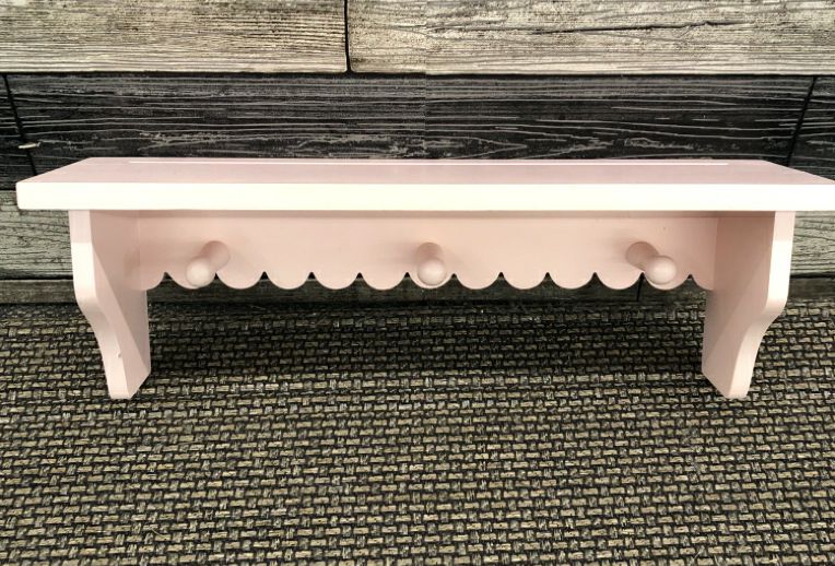 PINK WOOD WALL SHELF W/COAT HOOKS.