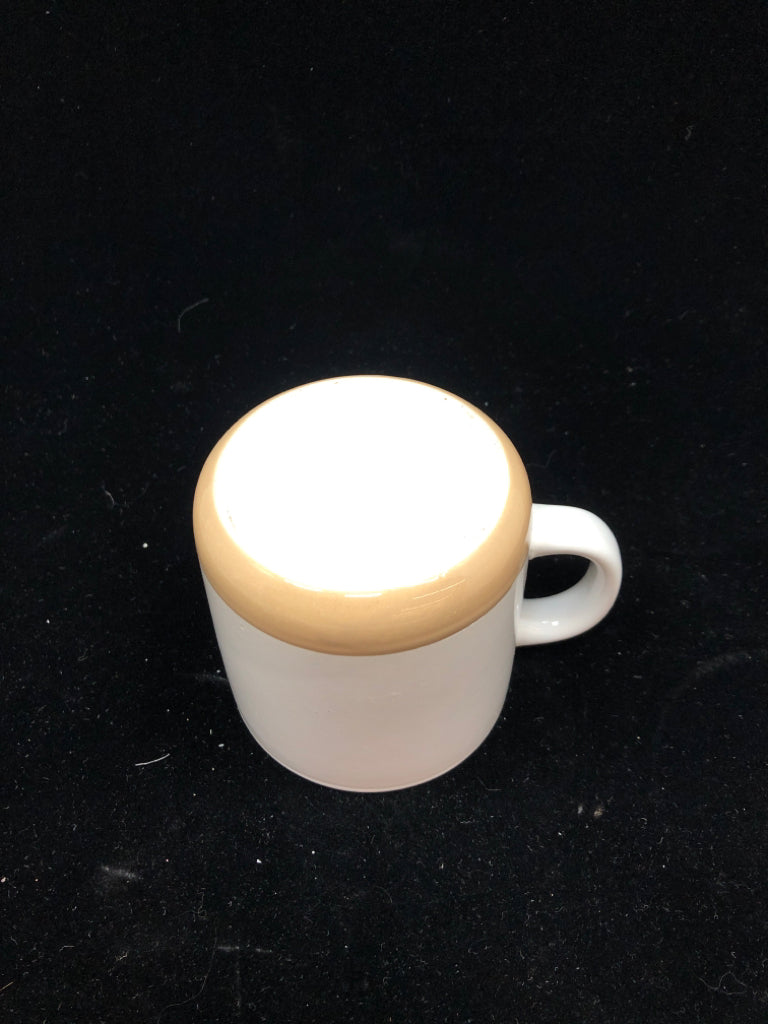 WHITE MUG W/BEIGE BOTTOM.