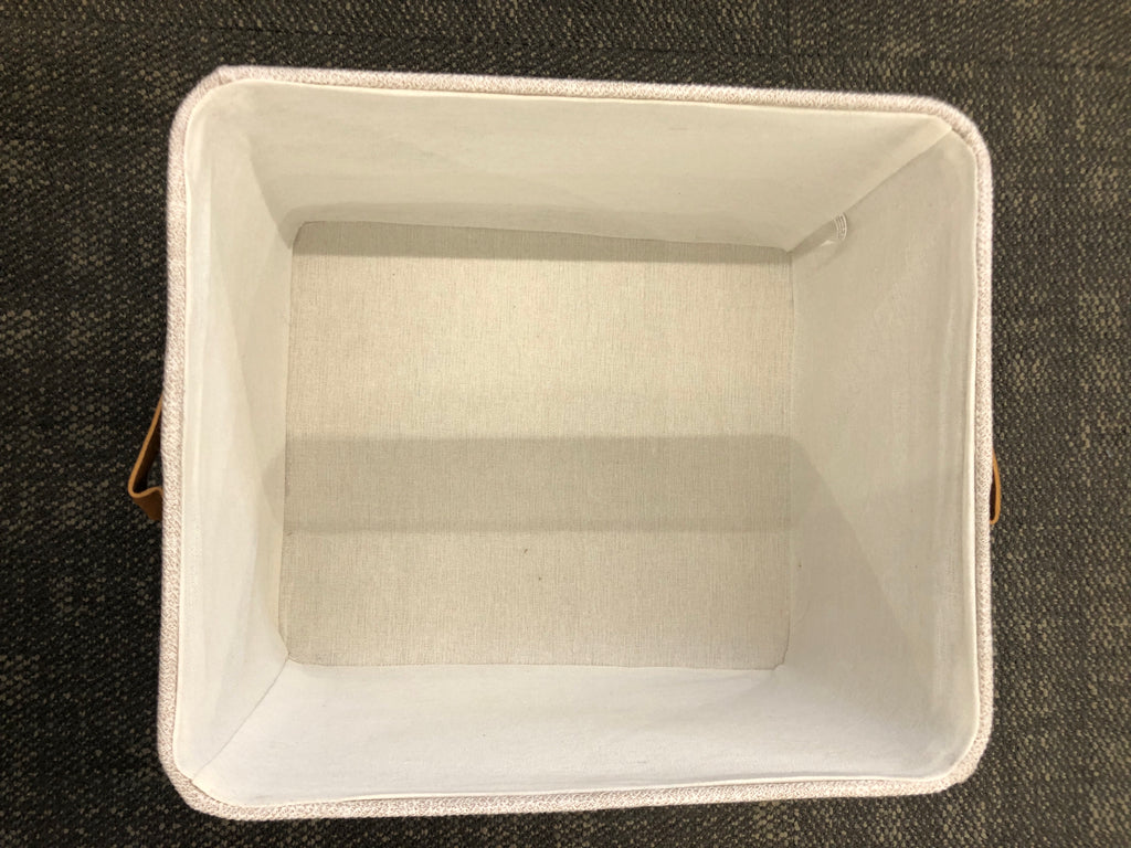 GREY FABRIC STORAGE BIN W/FAUX LEATHER HANDLES.