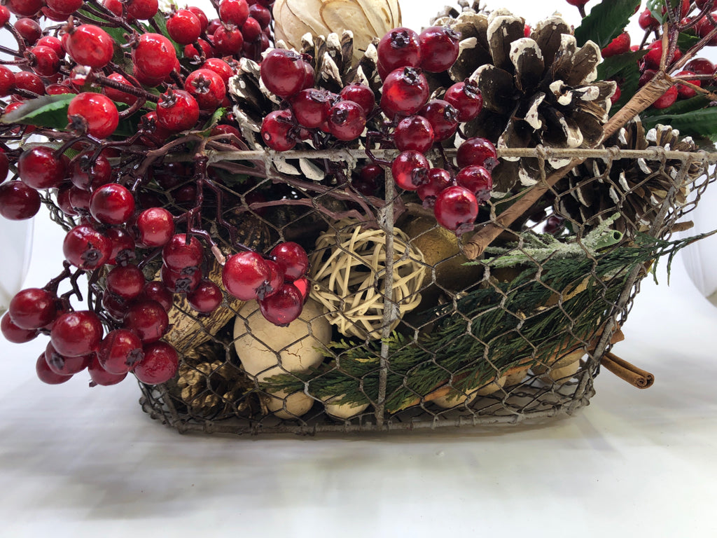 BASKET FULL OF FAUX HOLIDAY ARRANGEMENT.