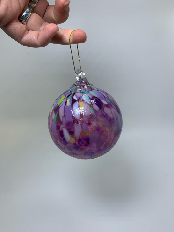 PINK BLOWN GLASS ORNAMENT W/ COLORFUL SPOTS.