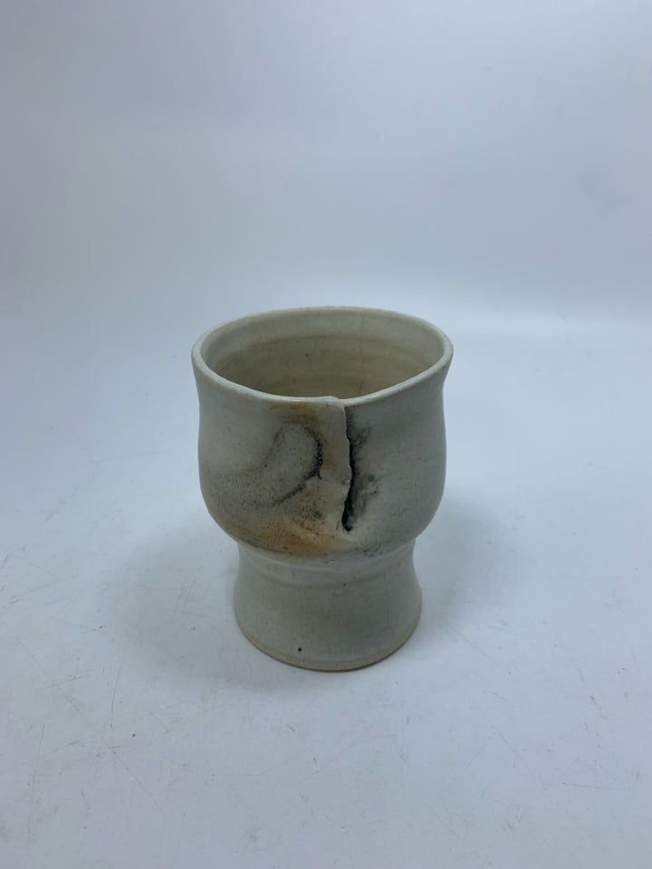 CREAM POTTERY IMPERFECT FOOTED CUP.