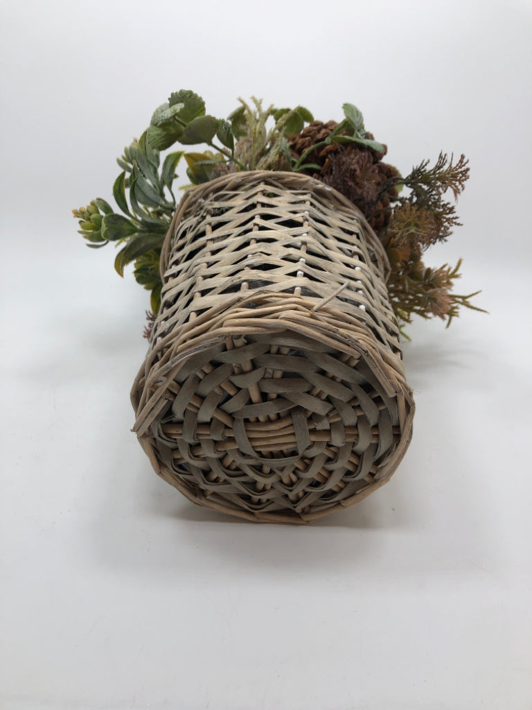 FAUX GREENERY ARRANGEMENT W/PINECONES IN WICKER VASE.