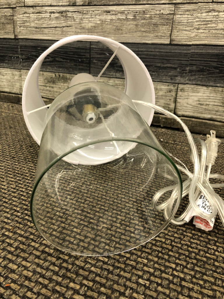 CLEAR GLASS LAMP W/WHITE SHADE.