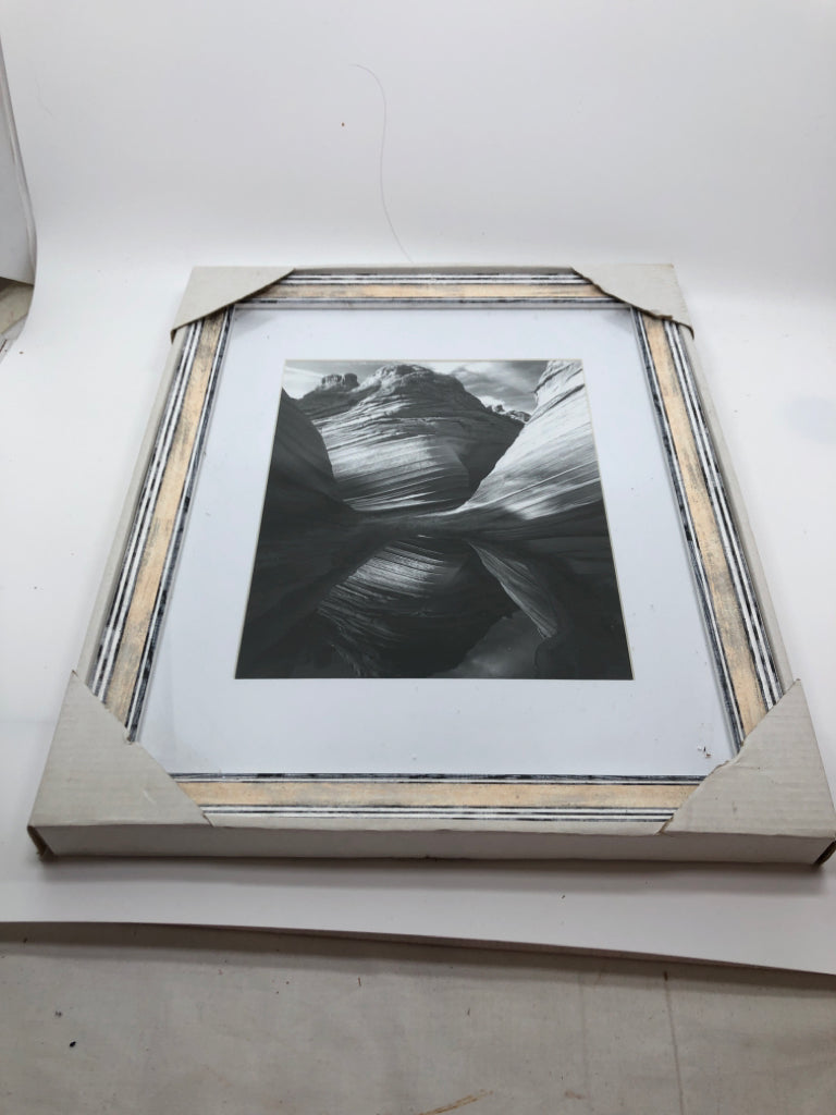 ROCK FORMATION BLACK/WHITE IN WHITE WASHED FRAME.