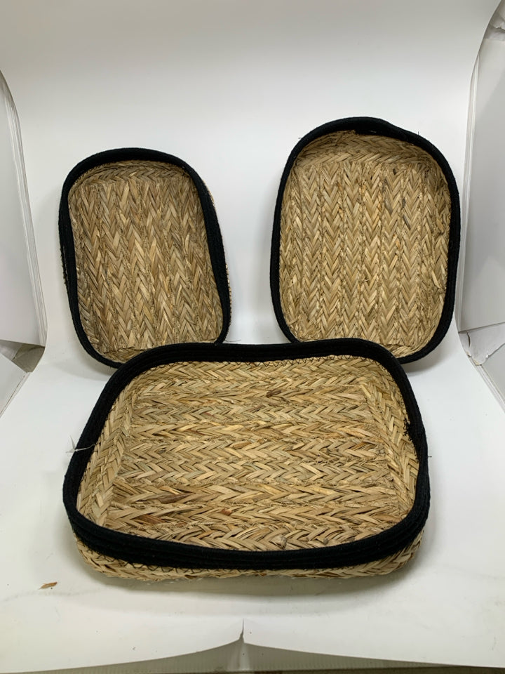 3 SHALLOW NESTING BASKETS W/ BLACK WOVEN EDGES.