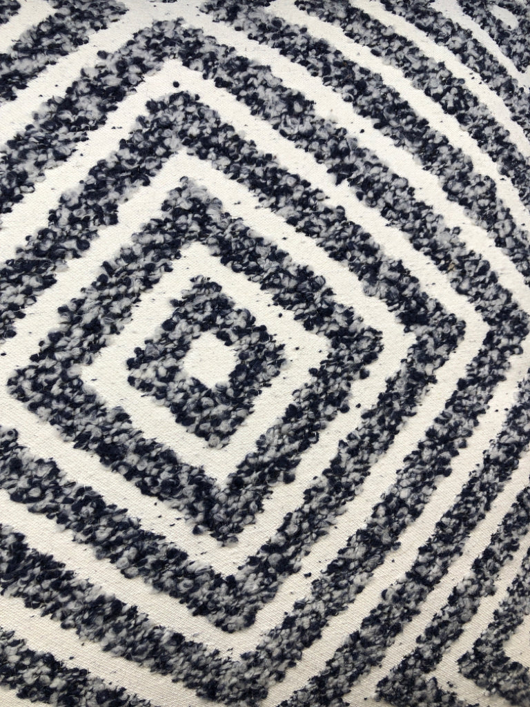 CREAM PILLOW W/BLUE TEXTURED DIAMOND DESIGN.