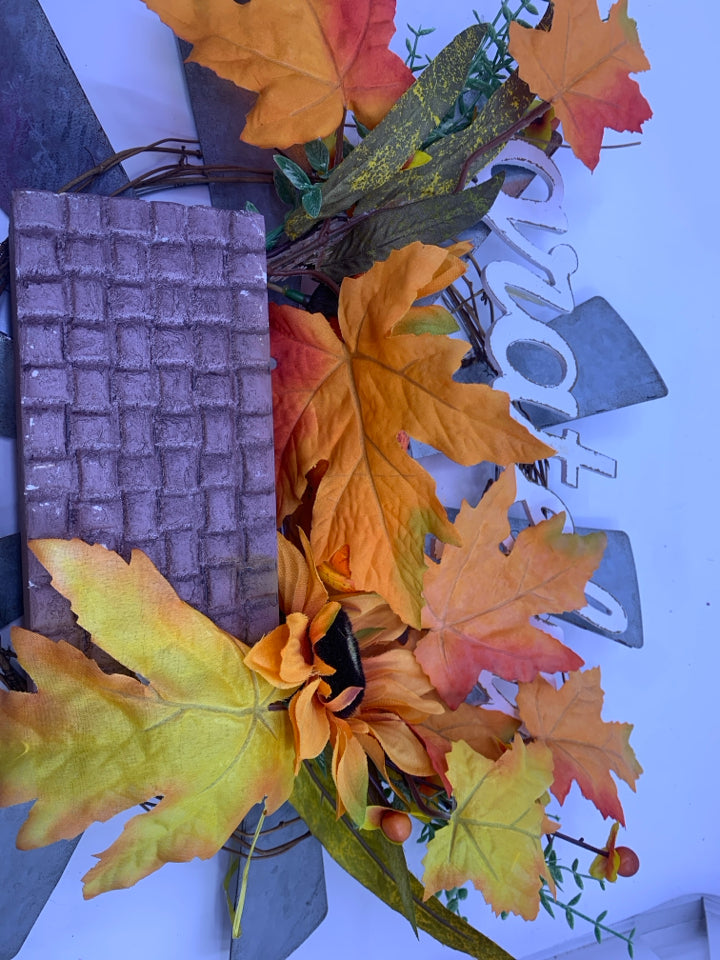 GRATEFUL METAL SUN WREATH W/ ORANGE LEAVES.