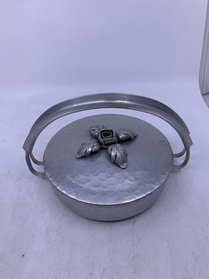 SILVER METAL HAMMERED SHALLOW W/ HANDLE EMBOSSED FLORAL ON LID.
