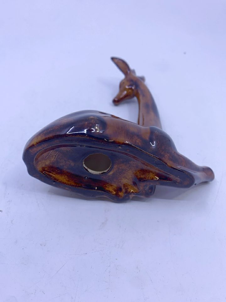 BROWN GIRAFFE LAYING DOWN FIGURE.