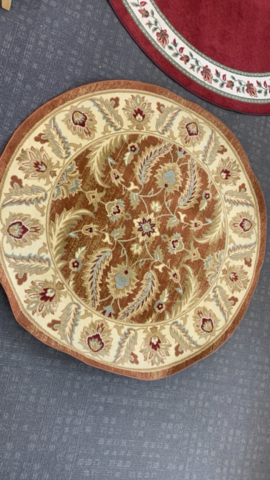 GOLDEN CIRCLE RUG W/LEAF DESIGNS.
