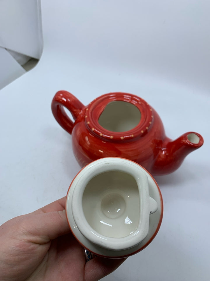 RED CERAMIC TEAPOT W/ ORANGE LINES.