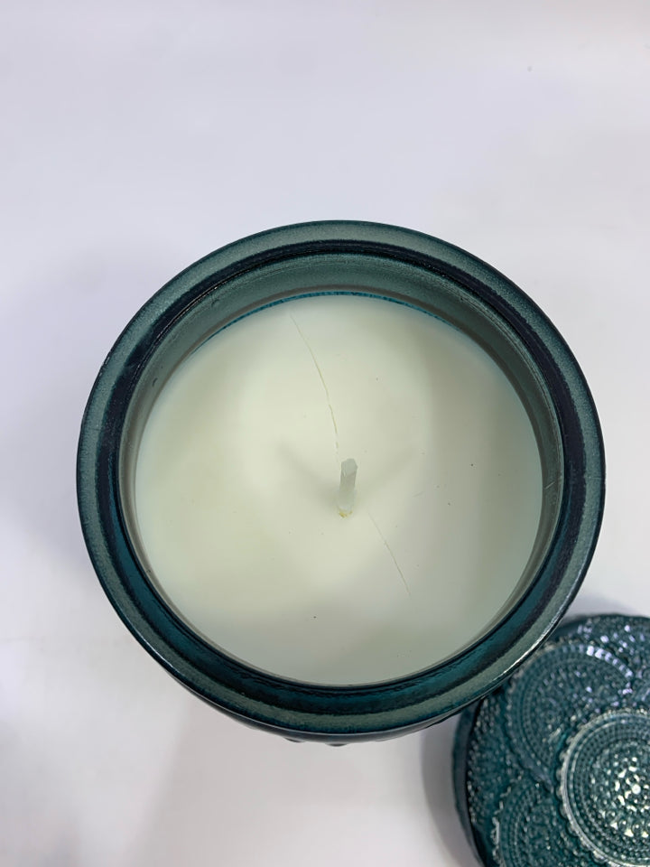 JASMINE SANTAL CANDLE IN GREEN GLASS JAR.