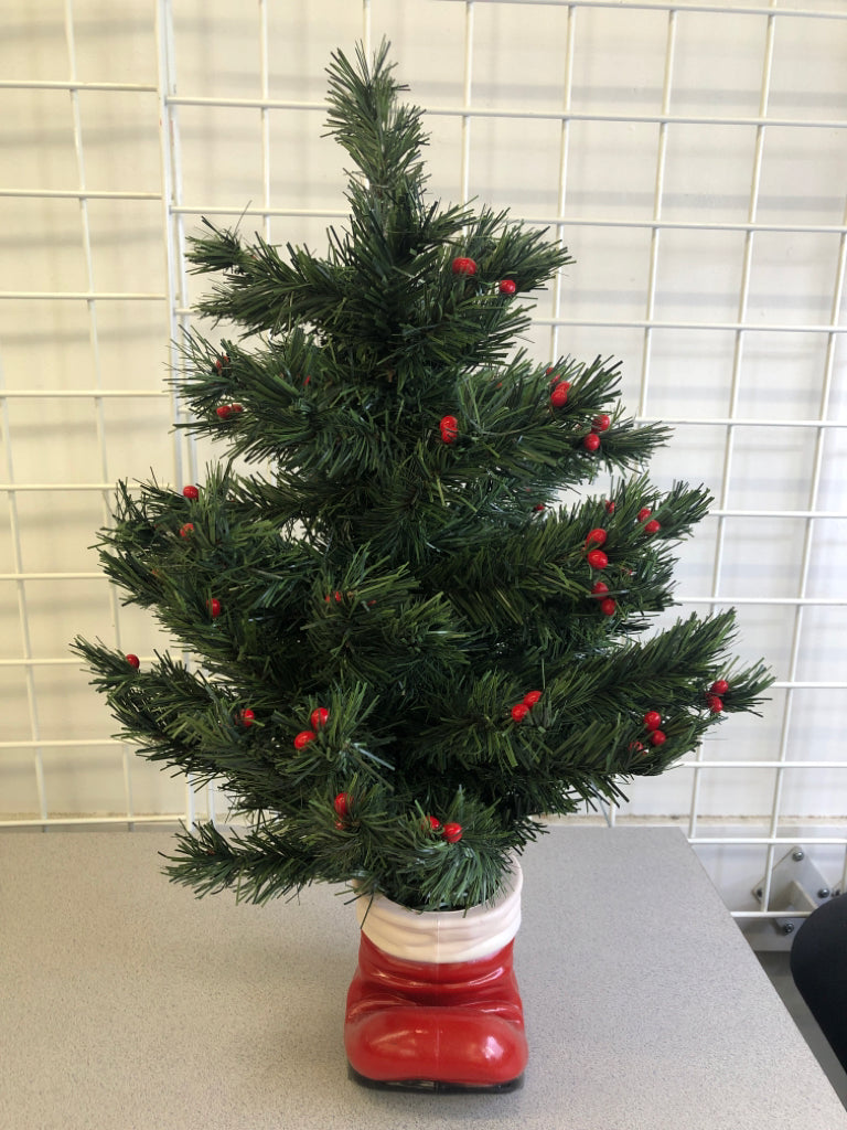 FAUX TREE W/BERRIES IN SANTAS BOOT.