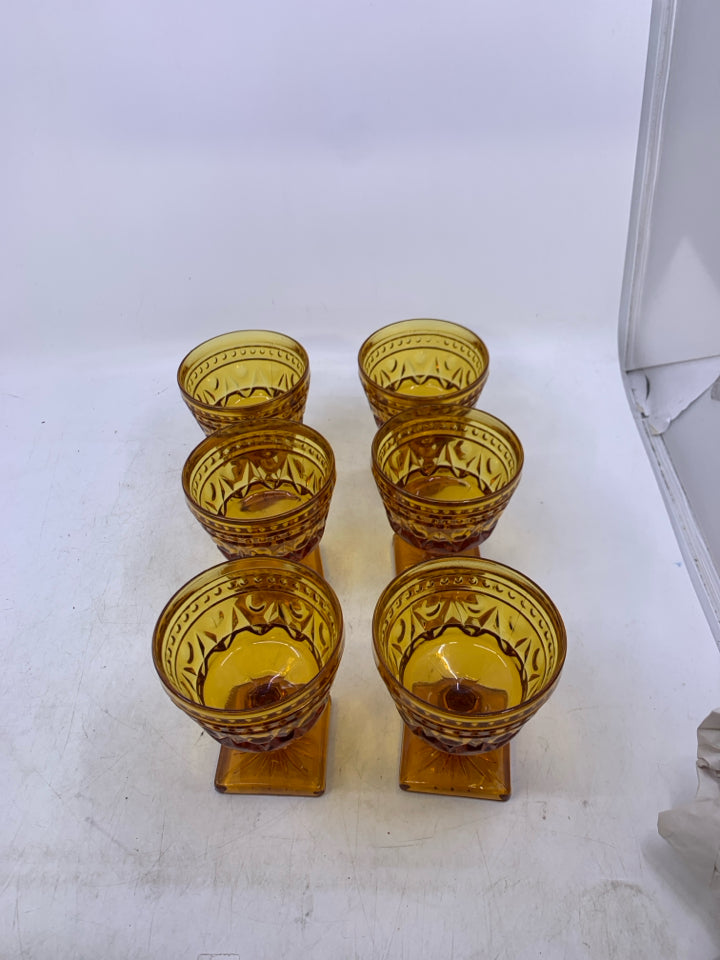 6 VTG FOOTED AMBER GLASSES W/ EMBOSSED DETAIL.