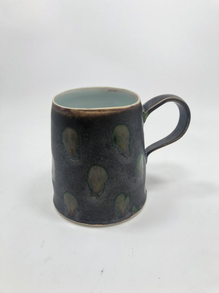 MATTE BLACK DOTTED POTTERY MUG W/INNER BLUE GLAZE.