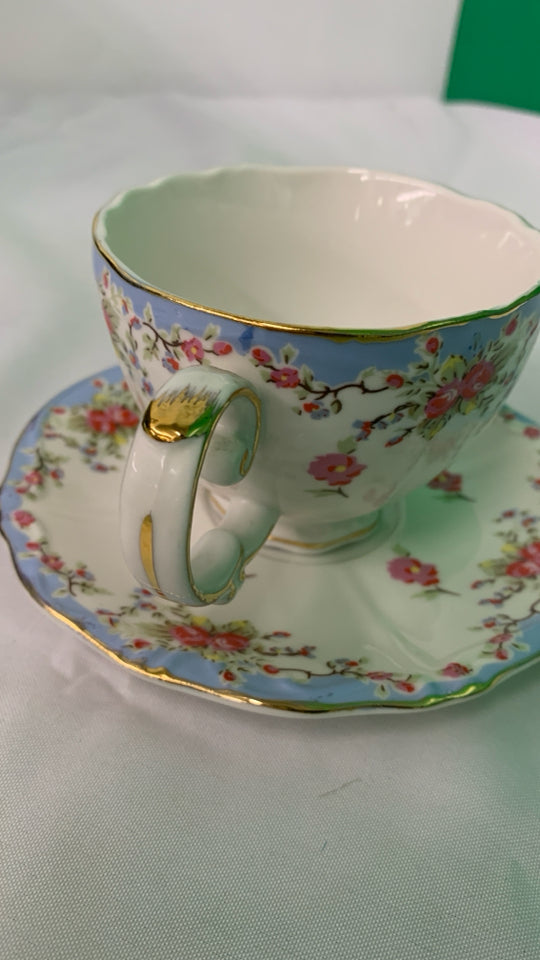 LIGHT BLUE W PINK FLORAL TEACUP AND SAUCER.