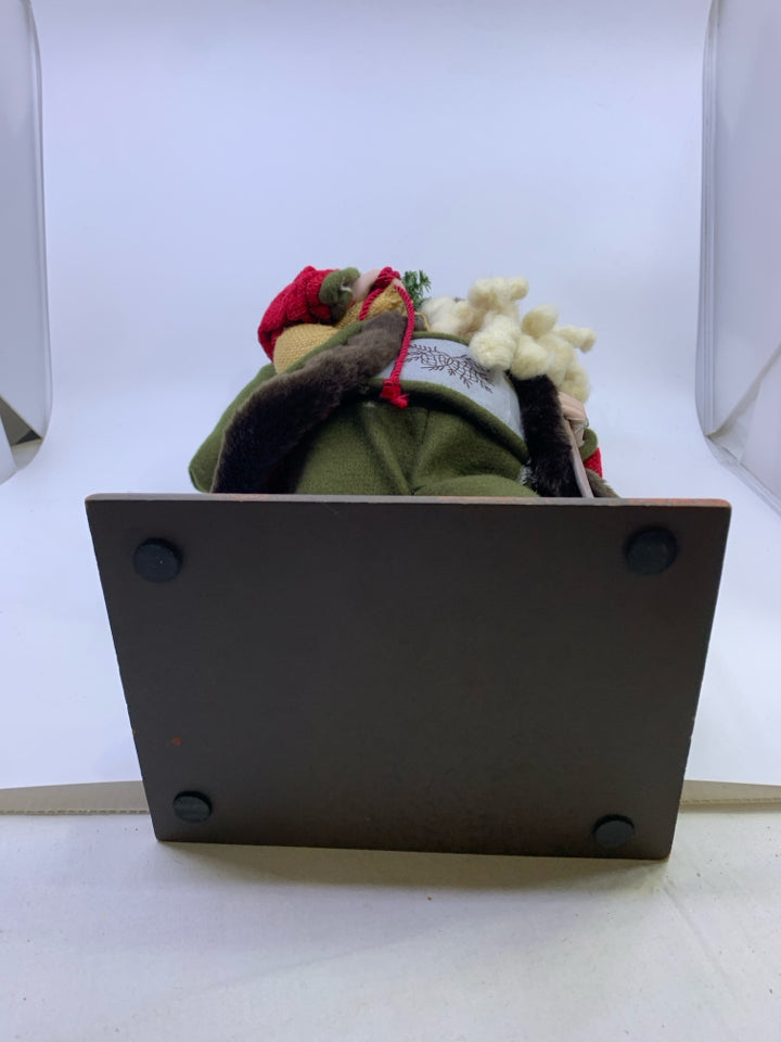 GREEN SANTA WITH DEER POLE HOLDING SACK.