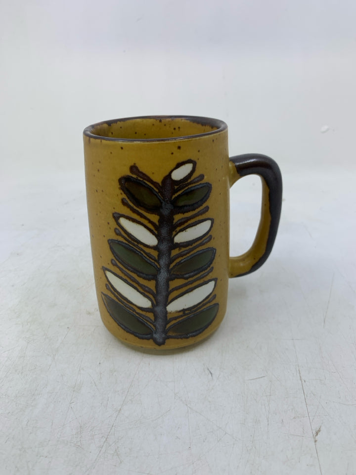 MUSTARD YELLOW POTTERY MUG W/ BROWN FLOWER DESIGN.