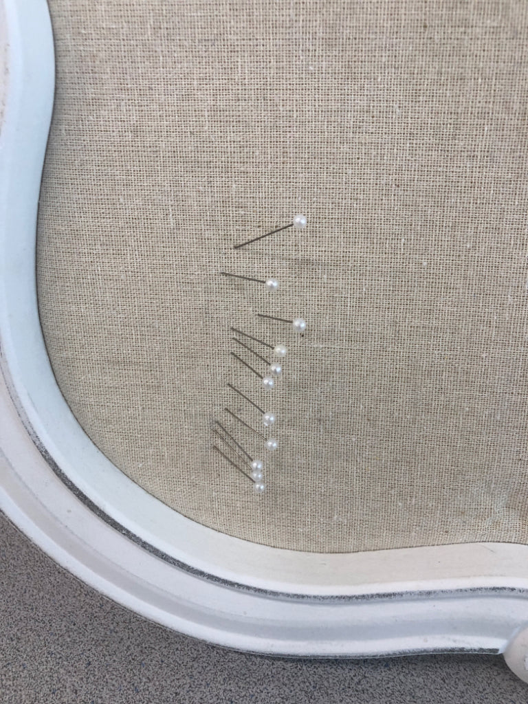 WHITE WOOD MEMO BOARD W/ATTACHED PINS.