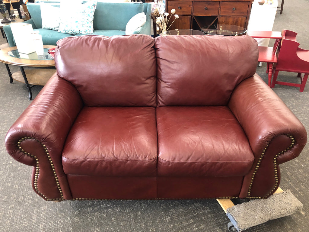DARK BROWN STUDDED LOVE SEAT.