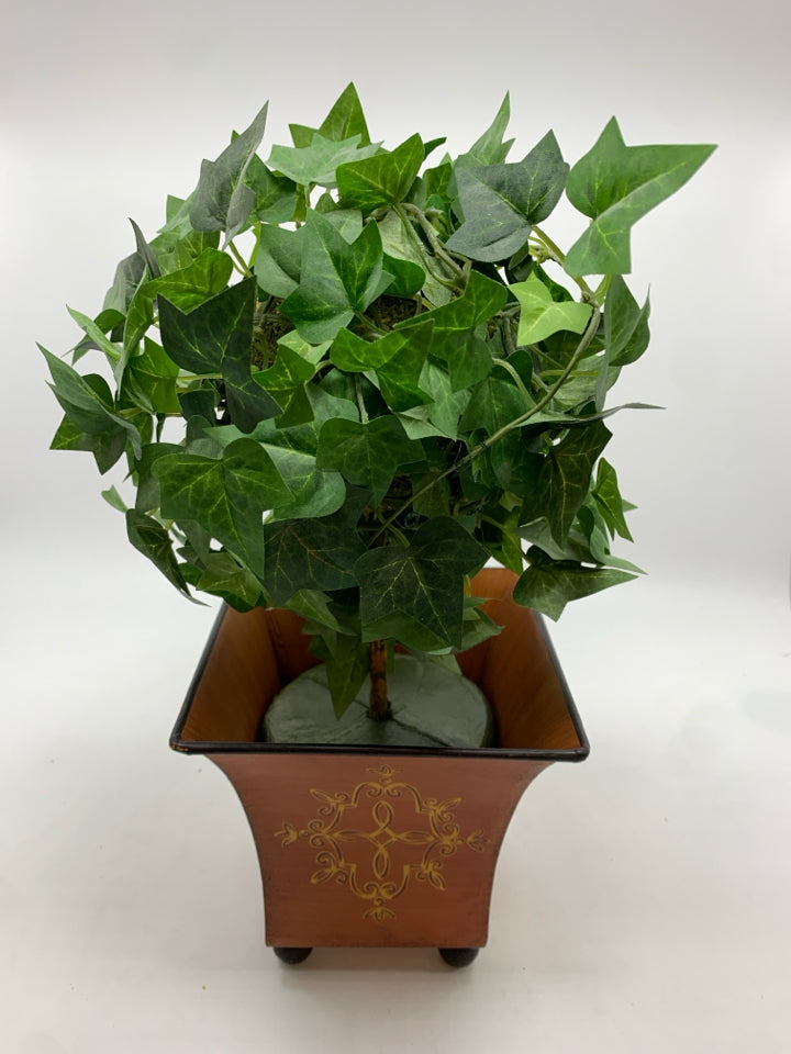 FAUX IVY TREE IN ORANGE METAL PLANTER.
