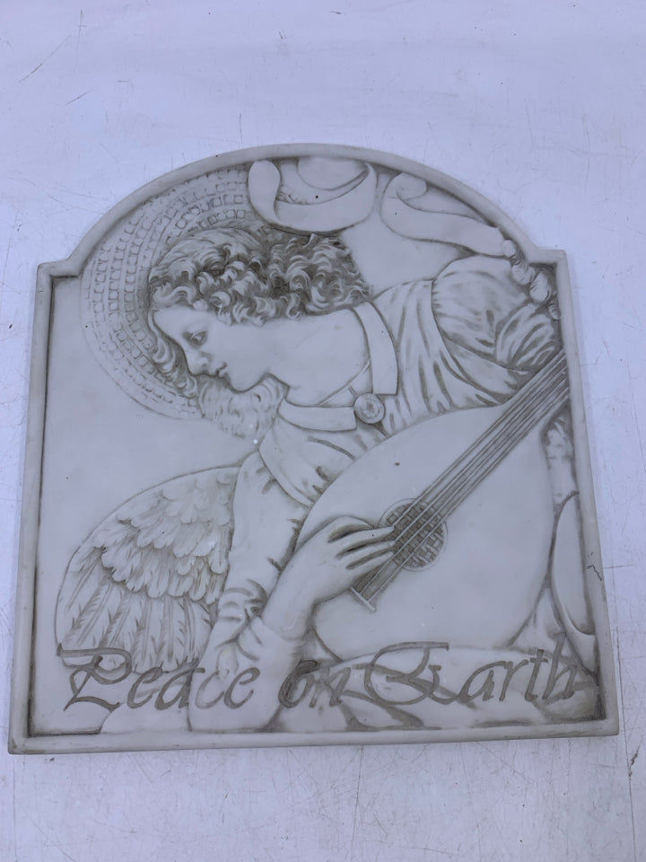 RESIN EMBOSSED FACE W/ INSTRUMENT PEACE ON EARTH.