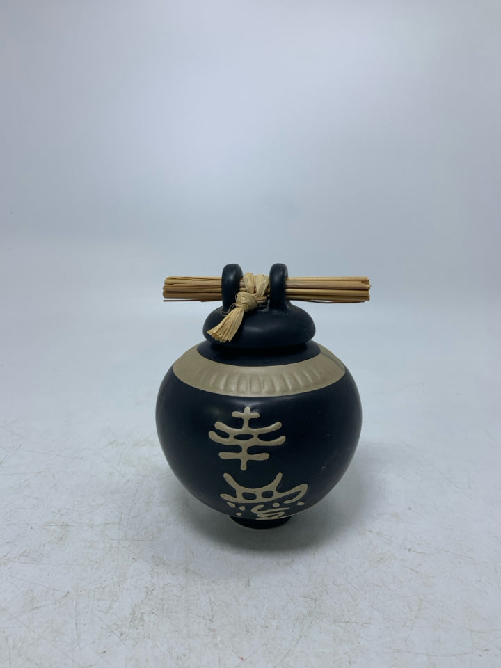 SMALL GINGER JAR W/ STICKS THROUGH TOP & SYBOLS.