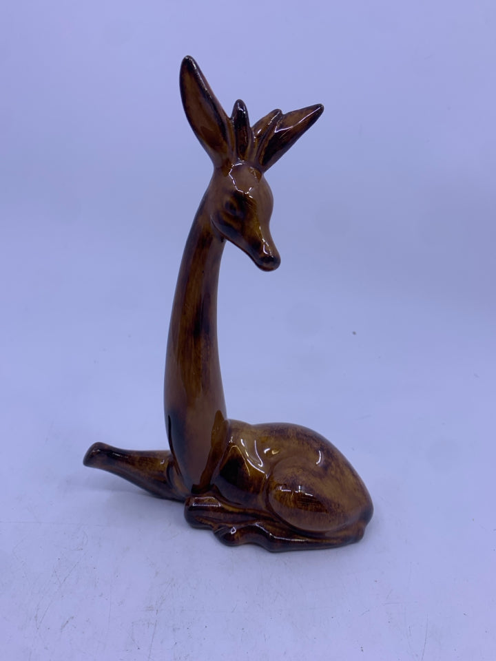 BROWN GIRAFFE LAYING DOWN FIGURE.