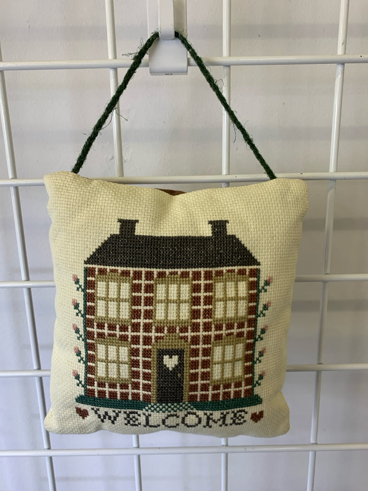 EMBROIDERED WELCOME PILLOW.