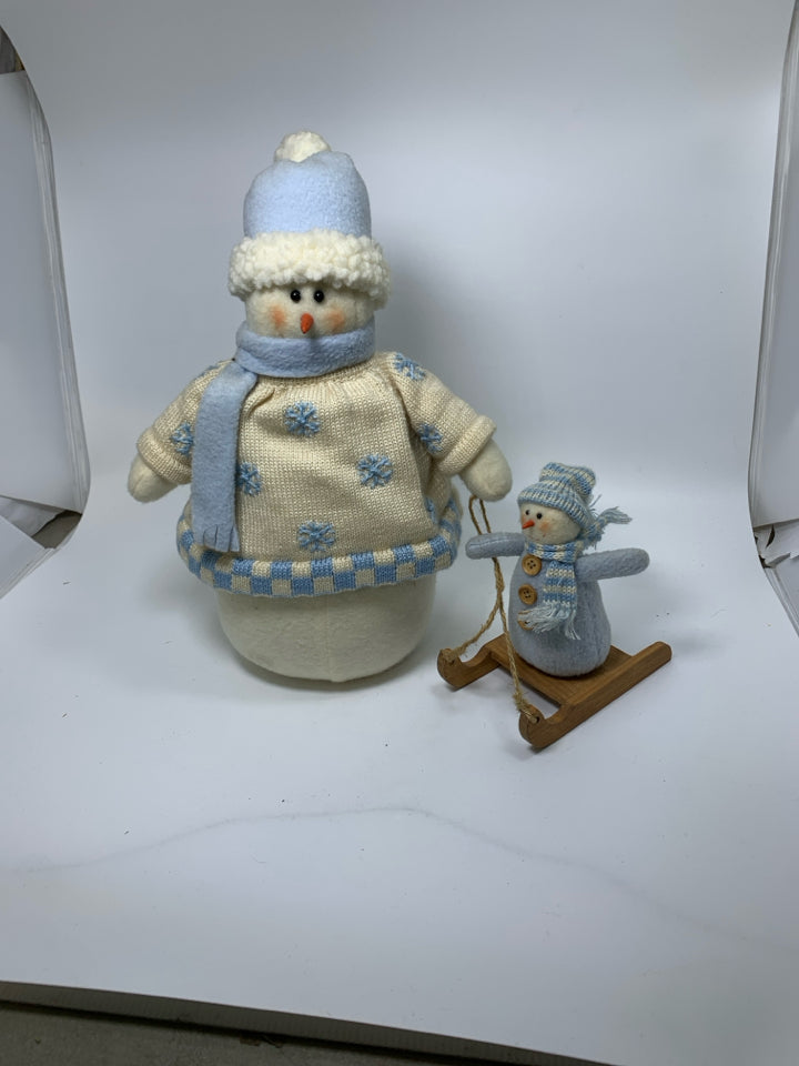 PLUSH WEIGHTED SNOWMAN PULLING BABY.