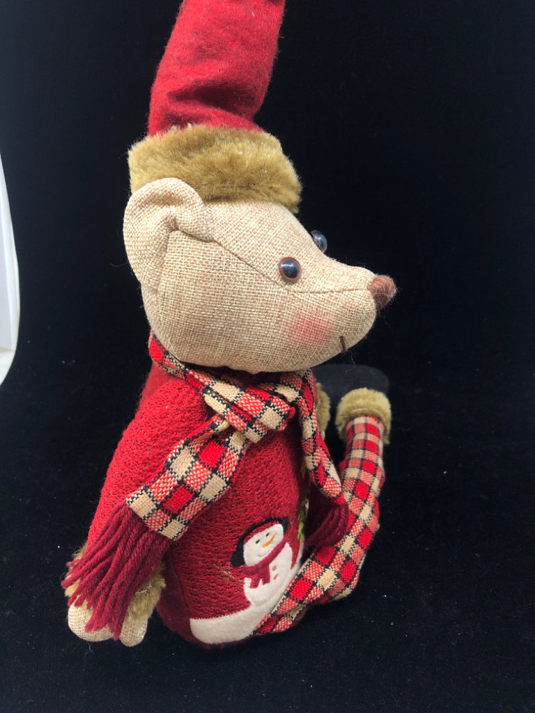 SHELF SITTING TEDDY IN RED COAT.