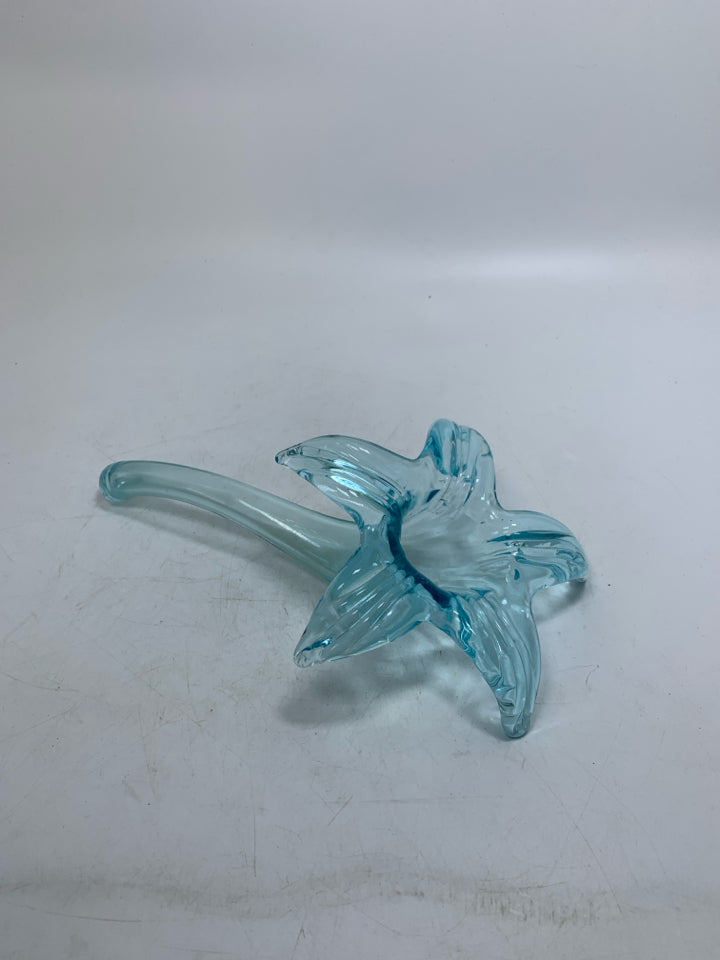 BLOWN GLASS LIGHT BLUE FLOWER LAYING FLAT.